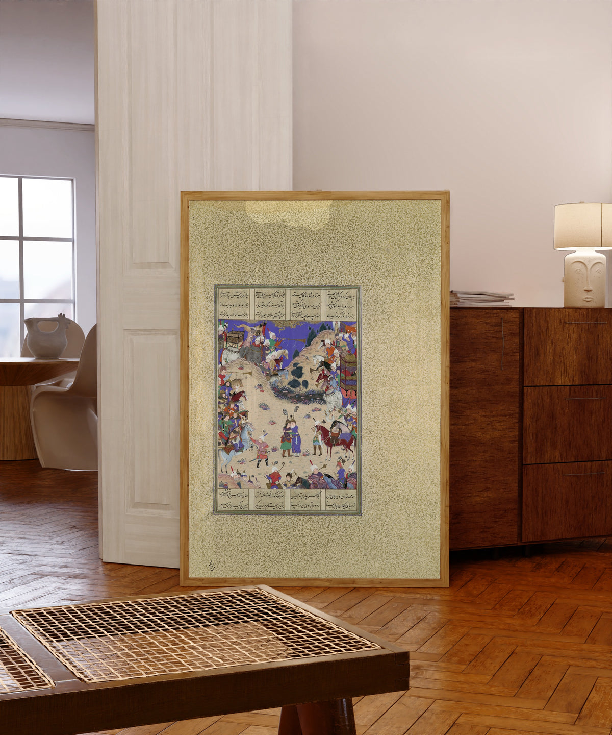 Framed art print of Shahnama of Shah Tahmasp: Faridun Embraces… by Qadimi (attributed), in a light wood frame leaning in a warm room with a parquet floor
