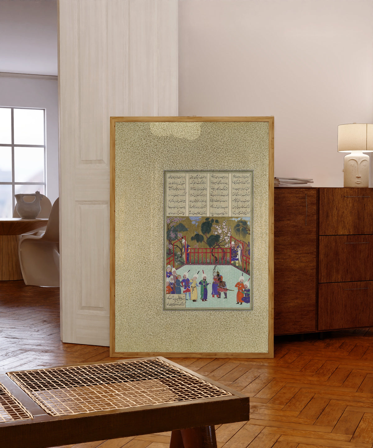 Framed art print of Shahnama of Shah Tahmasp: Kai Kavus and Rustam… by Qadimi (attributed), in a light wood frame leaning in a warm room with a parquet floor
