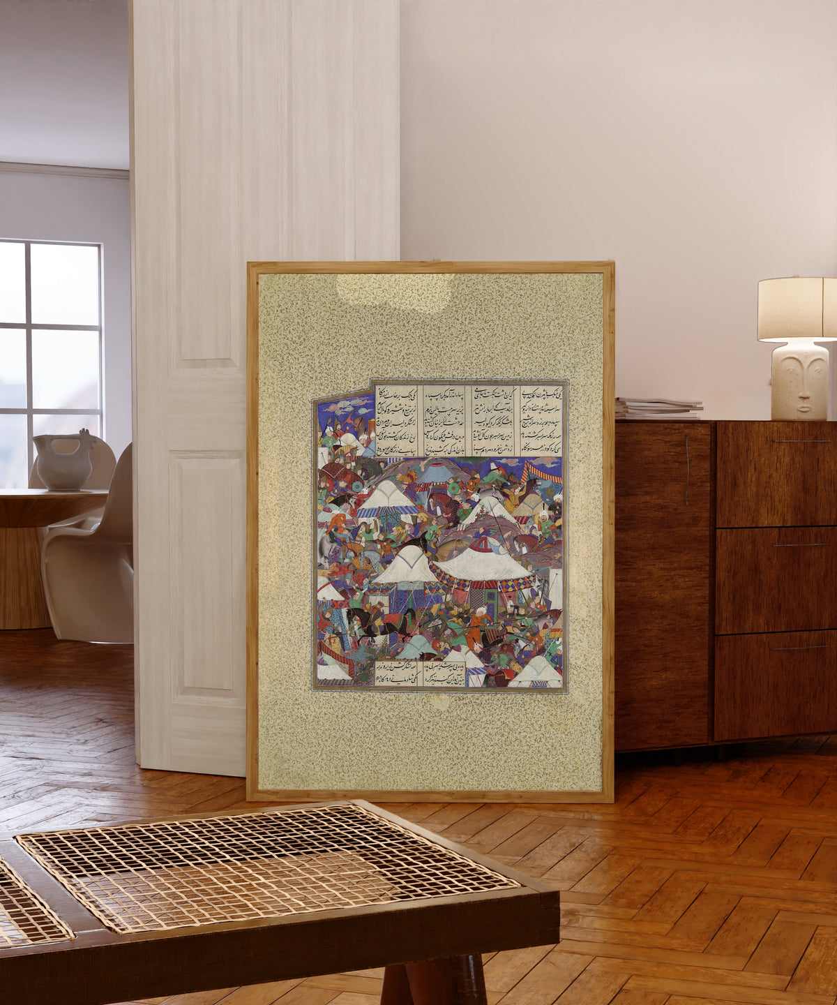 Framed art print of Shahnama of Shah Tahmasp: The Besotted Iranian… by Qadimi (attributed), in a light wood frame leaning in a warm room with a parquet floor