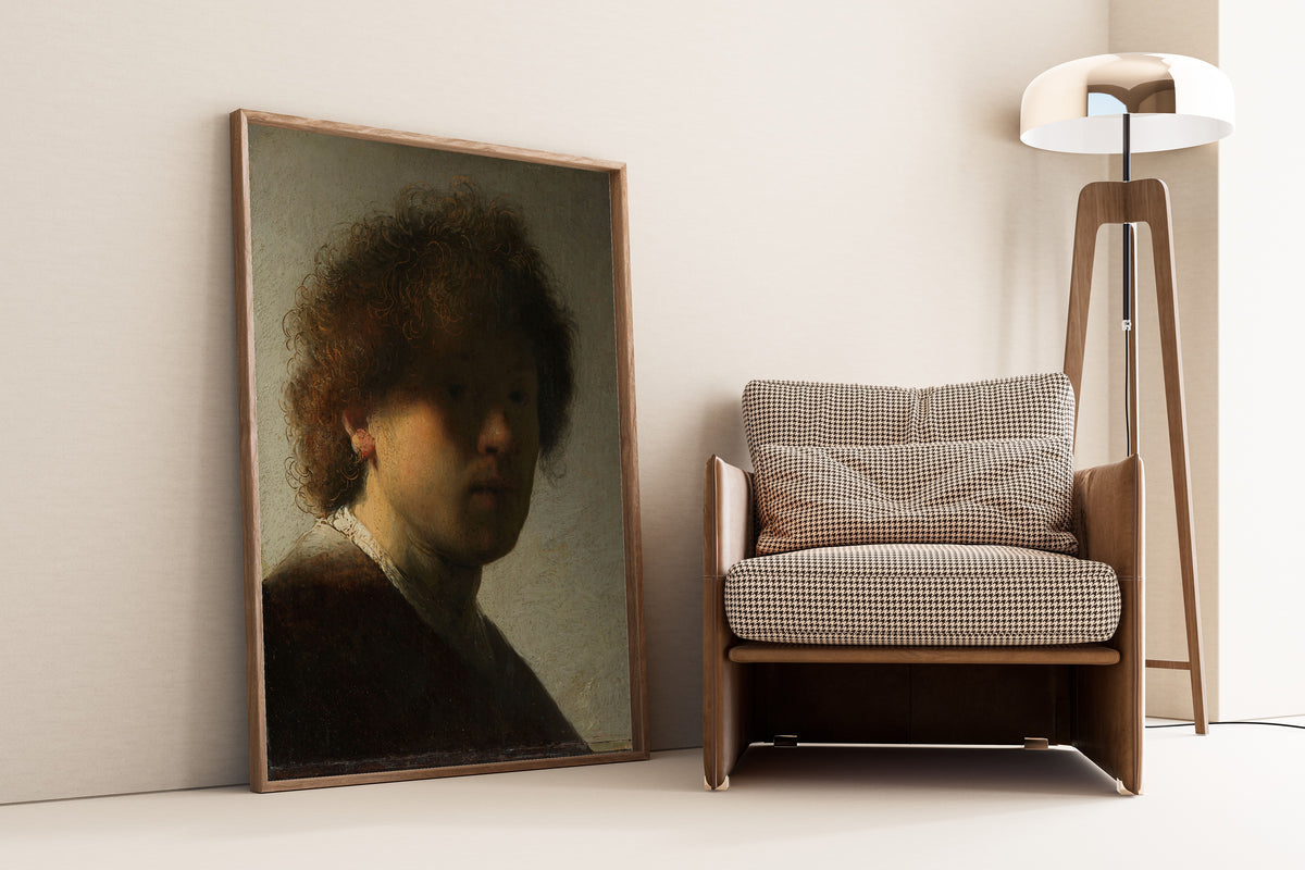 Self-portrait by Rembrandt van Rijn — framed and leaning against a wall beside an armchair and a floor lamp