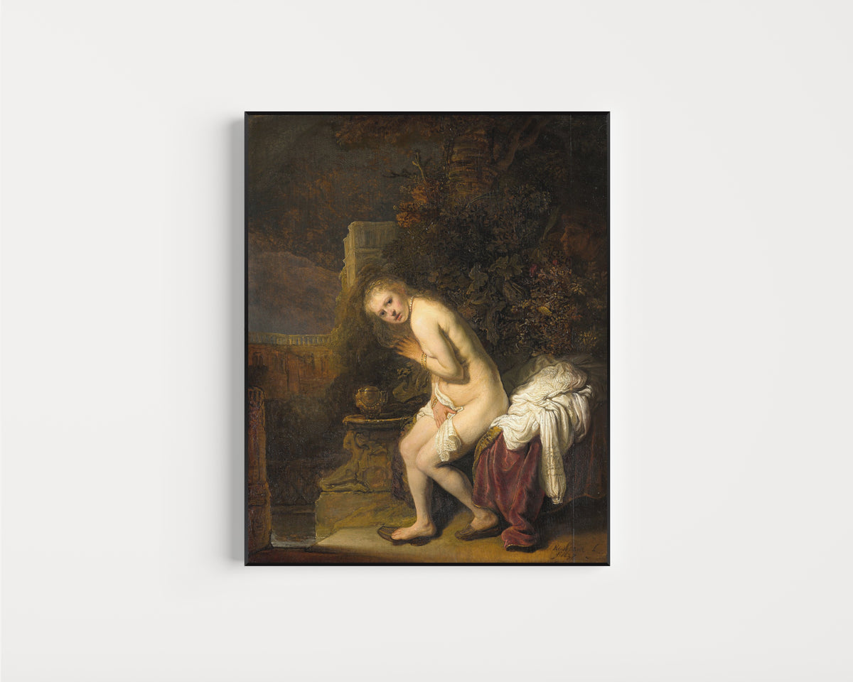 Framed art print of Susanna by Rembrandt van Rijn, in a slim black frame on a plain white wall