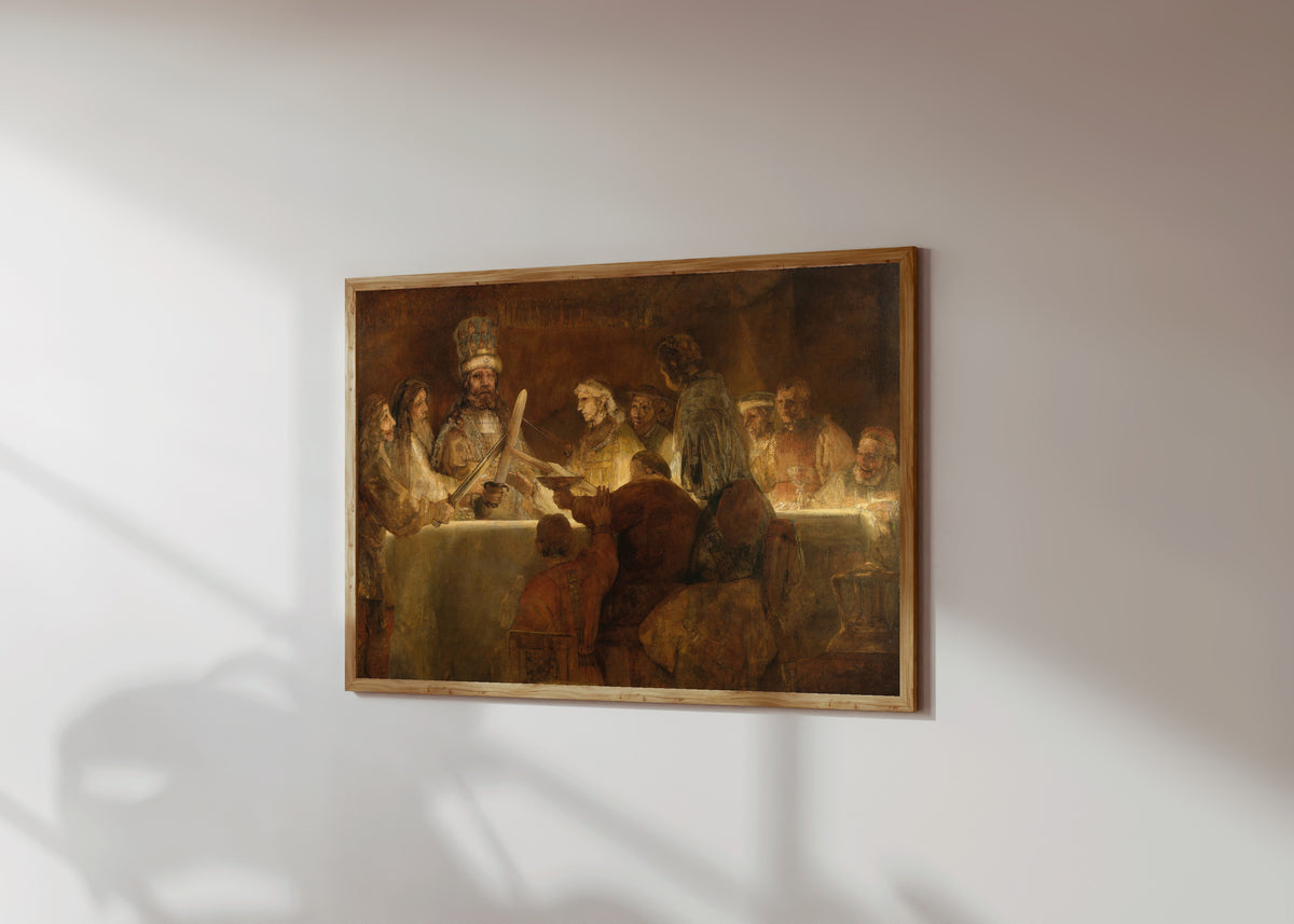 Framed art print of The Conspiracy of the Batavians under Claudius… by Rembrandt van Rijn, in a light wood frame on a sunlit white wall, seen at a slight angle