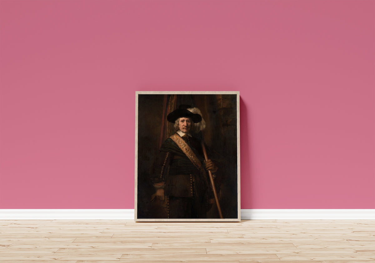 Framed art print of The Standard Bearer (probably Floris Soop… by Rembrandt van Rijn, in a light wood frame leaning on a pink wall above a wooden floor