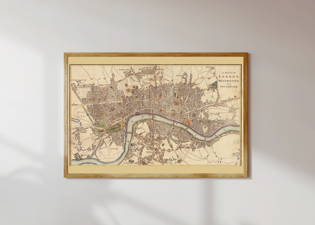 Framed art print of A Plan of London, Westminster and Southwark by Richard Phillips, in a light wood frame on a sunlit white wall