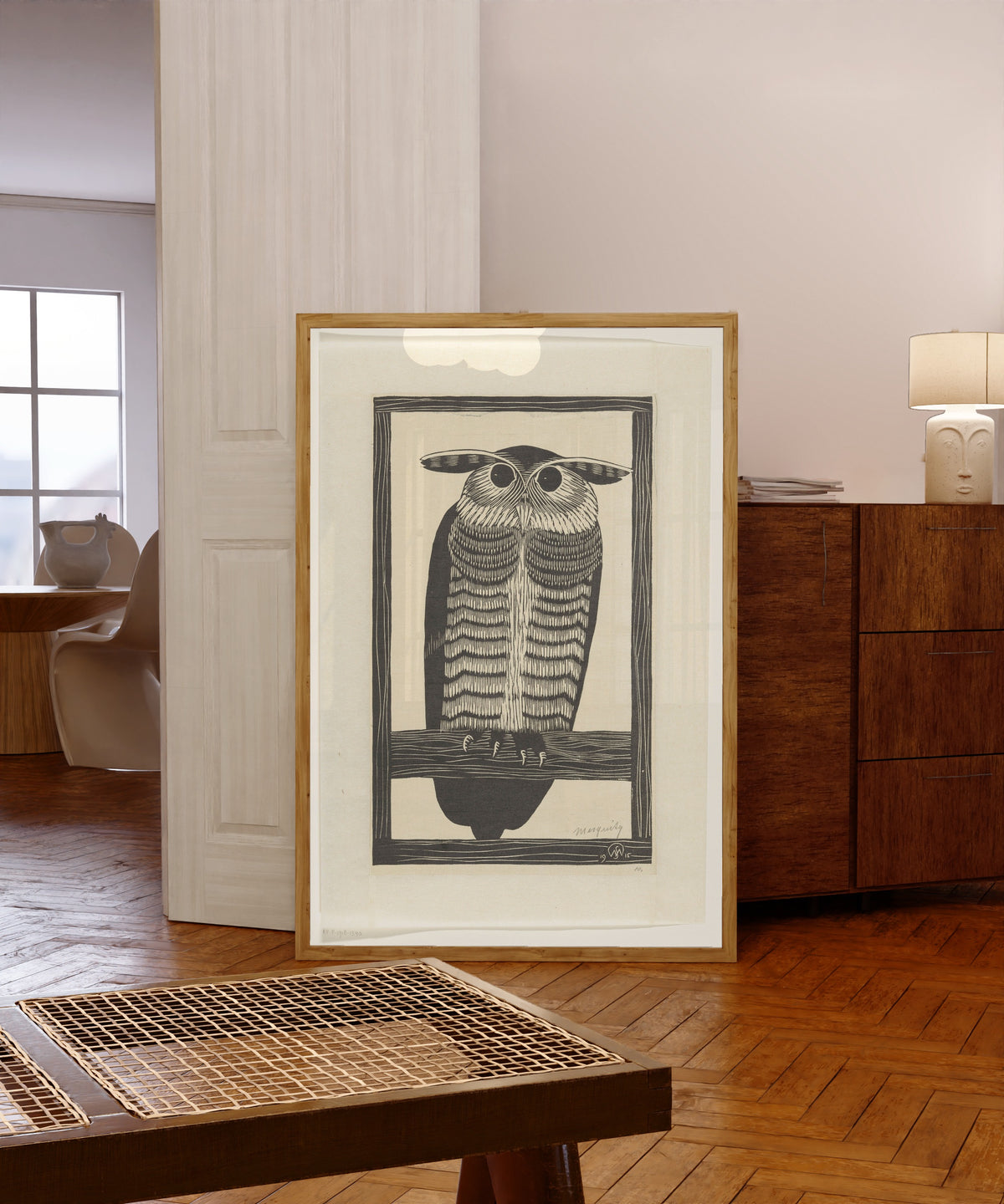 Framed art print of Hoornuil [Long-eared owl] by Samuel Jessurun de Mesquita, in a light wood frame leaning in a warm room with a parquet floor