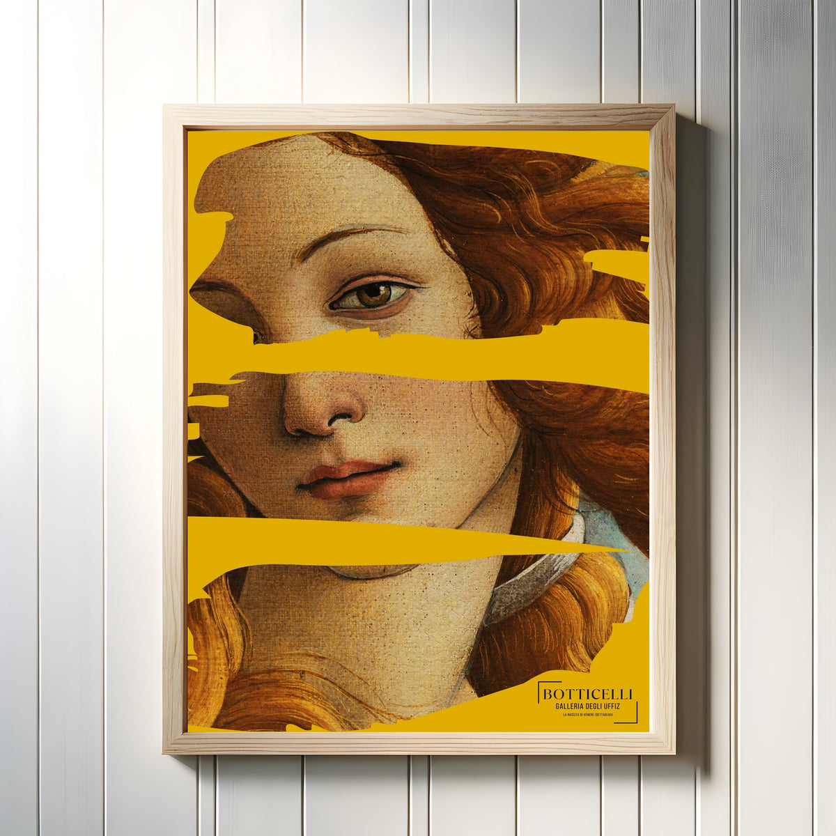 Framed art print of The Birth of Venus (Detail) by Sandro Botticelli, in a light wood frame on a white panelled wall