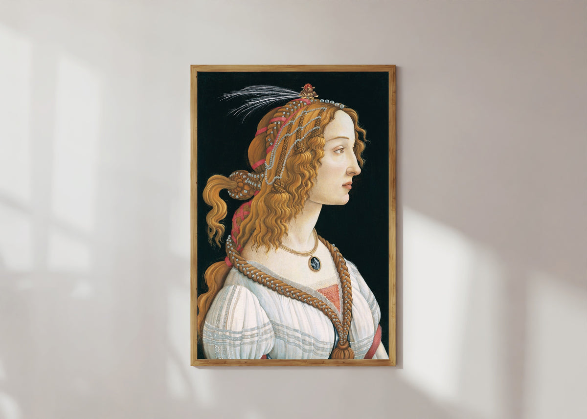 Framed art print of Idealized Portrait of a Lady by Sandro Botticelli, in a light wood frame on a sunlit white wall