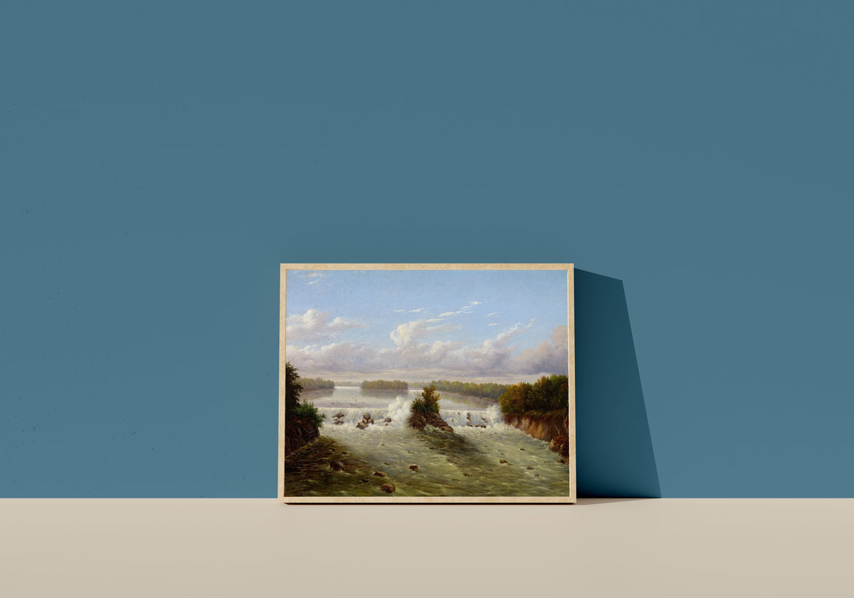 Framed art print of The Falls of St. Anthony by Seth Eastman, in a light wood frame leaning on a blue wall