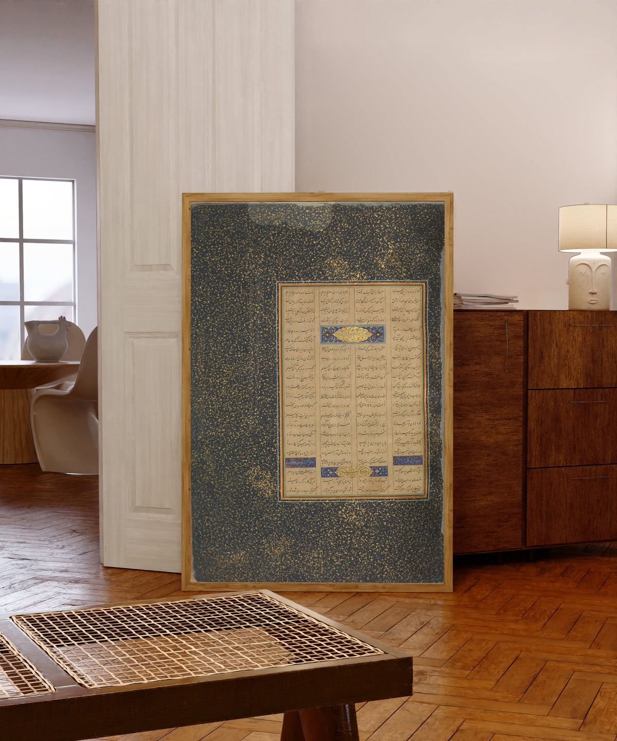 Framed art print of Page of Calligraphy from a Mantiq al-Tayr… by Sultan 'Ali al-Mashhadi, in a light wood frame leaning in a warm room with a parquet floor