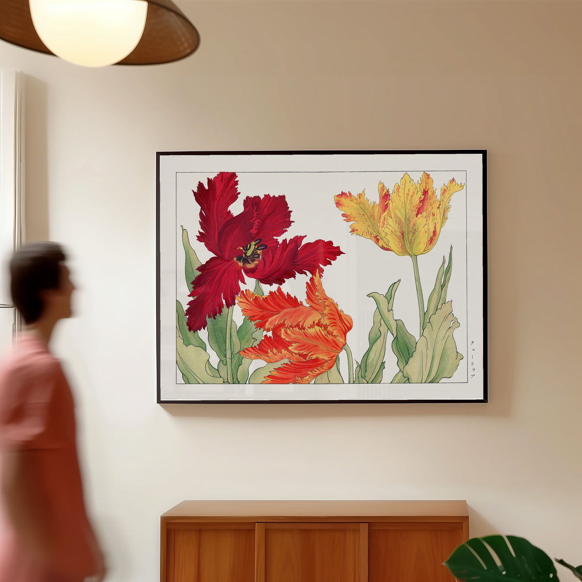 Framed art print of Parrot tulip by Tanigami Kōnan, in a slim black frame on a warm wall in a sunlit room