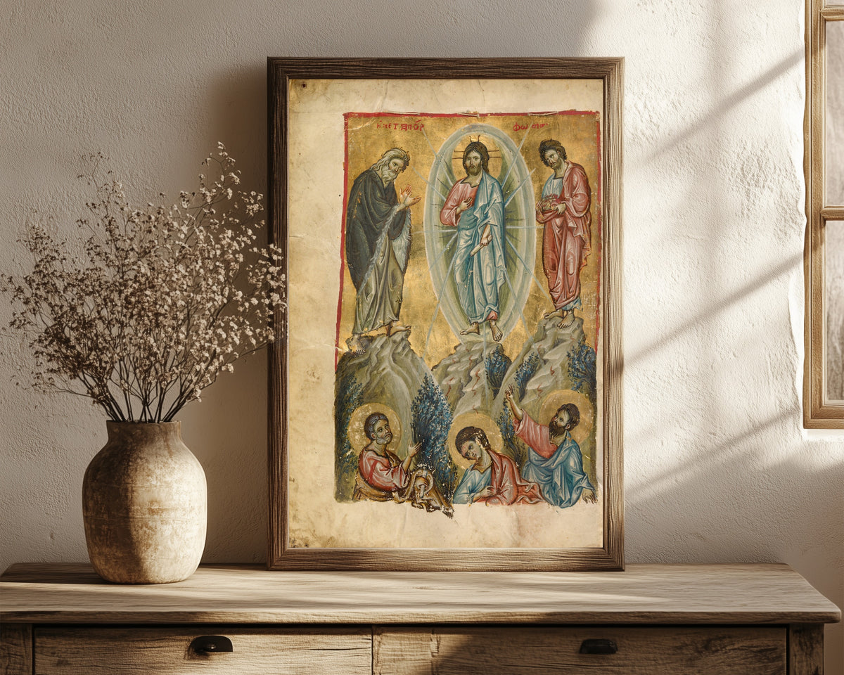 Framed art print of The Transfiguration, in a dark wood frame leaning on a rustic console beside dried flowers