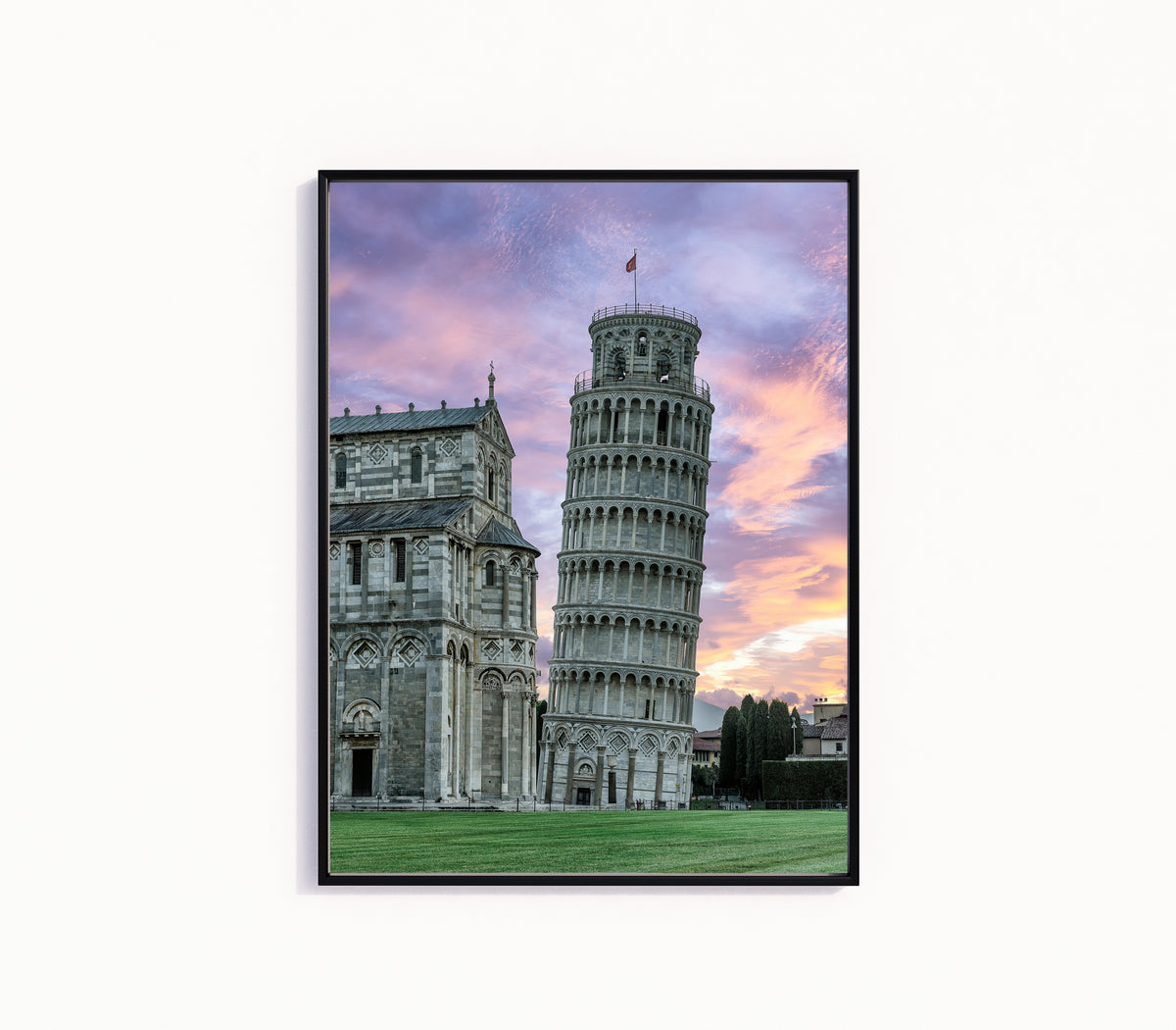 Framed art print of Tower of Pisa by Pablo Meilán Campagnale, in a slim black frame on a plain white wall