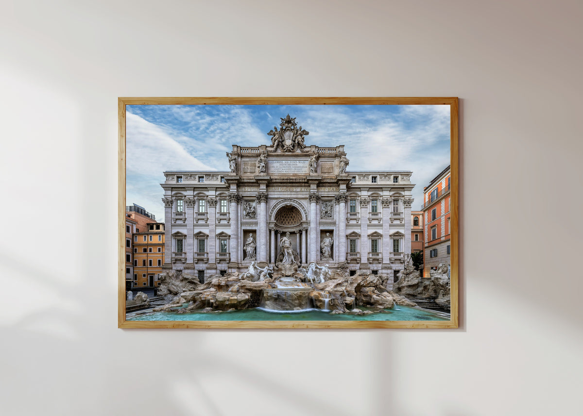 Framed art print of Trevi Fountain (Rome) by Pablo Meilán Campagnale, in a light wood frame on a sunlit white wall