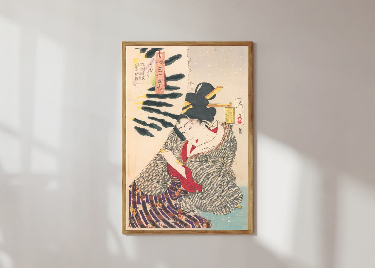 Framed art print of Fūzoku sanjūni sō: Looks Cold (Tenpō-era Fukagawa geisha) by Tsukioka Yoshitoshi, in a light wood frame on a sunlit white wall