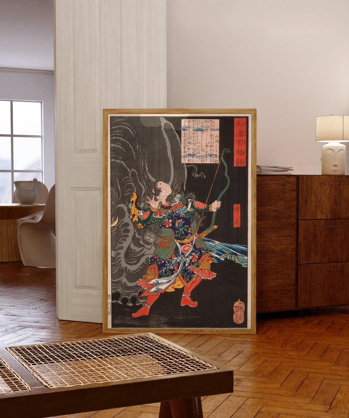Framed art print of Jiang Wu (Shōbu) and the Elephant by Tsukioka Yoshitoshi, in a light wood frame leaning in a warm room with a parquet floor