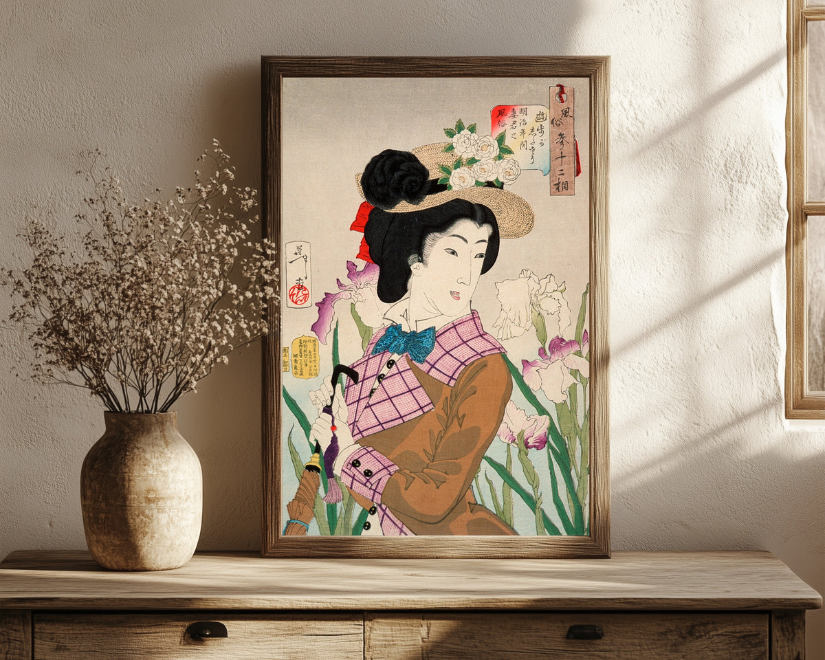 Framed art print of Preparing to Take a Stroll; The Wife of a… by Tsukioka Yoshitoshi, in a dark wood frame leaning on a rustic console beside dried flowers