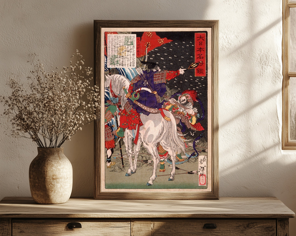 Framed art print of Sakanoue Tamuramaro in Rain of Arrows by Tsukioka Yoshitoshi, in a dark wood frame leaning on a rustic console beside dried flowers