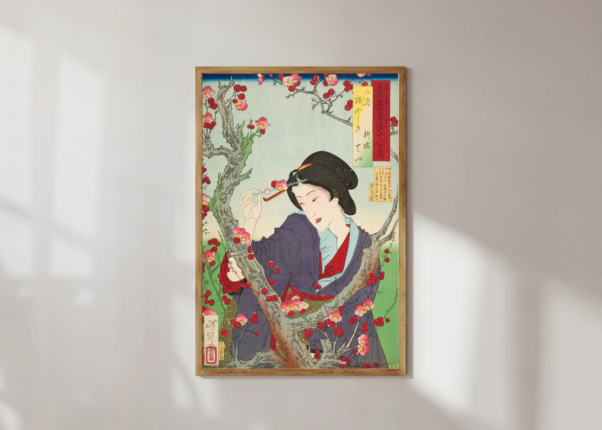 Framed art print of Second Month; Tei of Shinbashi by a Plum Tree at Umeyashiki by Tsukioka Yoshitoshi, in a light wood frame on a sunlit white wall