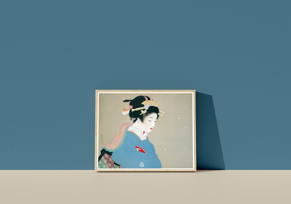 Framed art print of Snow in the Garden by Uemura Shōen, in a light wood frame leaning on a blue wall