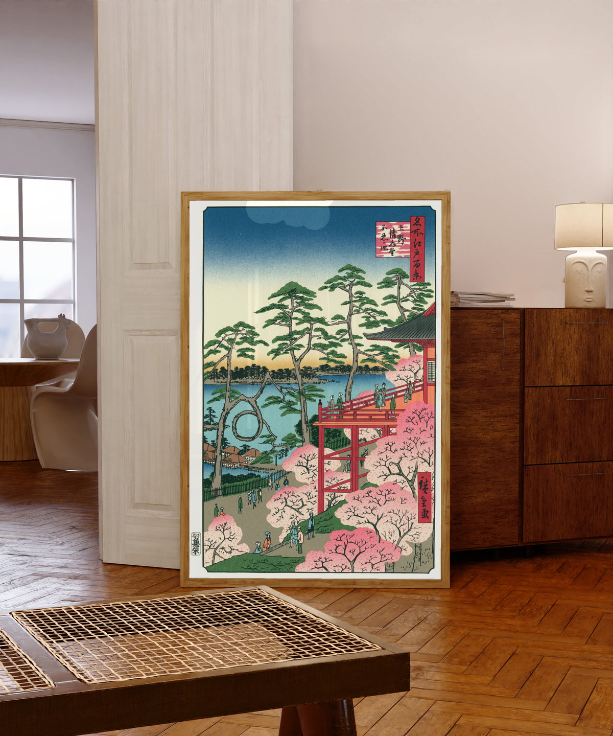 Framed art print of Kiyomizu Hall and Shinobazu Pond at Ueno by Utagawa Hiroshige, in a light wood frame leaning in a warm room with a parquet floor