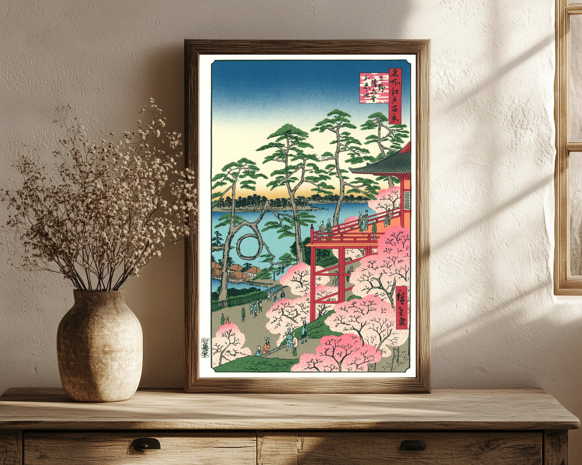 Framed art print of Kiyomizu Hall and Shinobazu Pond at Ueno by Utagawa Hiroshige, in a dark wood frame leaning on a rustic console beside dried flowers