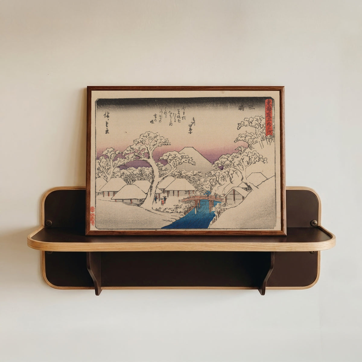 Framed art print of Kyōka Tōkaidō: Mishima by Utagawa Hiroshige, in a dark wood frame resting on a wall shelf