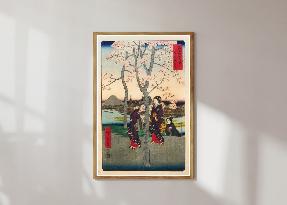 Framed art print of The Sumida Embankment in the Eastern Capital by Utagawa Hiroshige, in a light wood frame on a sunlit white wall
