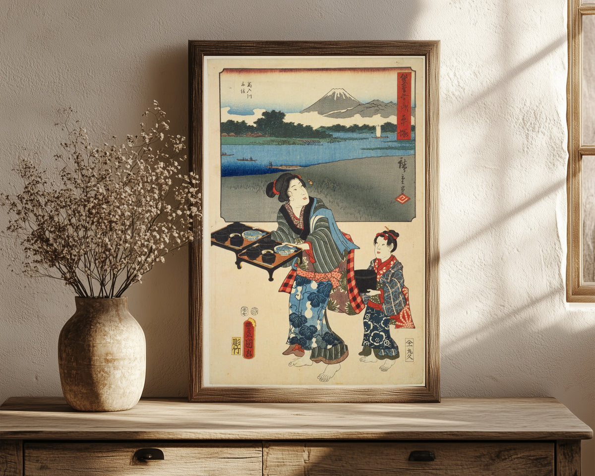 Framed art print of Fifty-three Stations by Two… by Utagawa Hiroshige & Utagawa Kunisada, in a dark wood frame leaning on a rustic console beside dried flowers