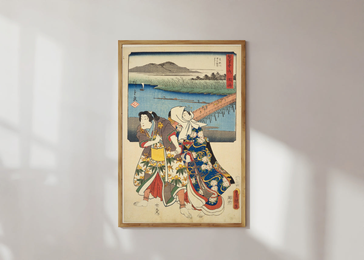 Framed art print of Fifty-three Stations by Two Brushes: Okazaki by Utagawa Hiroshige & Utagawa Kunisada, in a light wood frame on a sunlit white wall