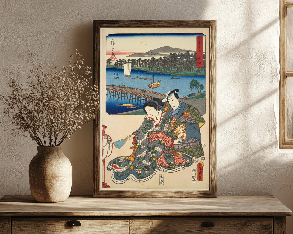 Framed art print of Fifty-three Stations by Two… by Utagawa Hiroshige & Utagawa Kunisada, in a dark wood frame leaning on a rustic console beside dried flowers