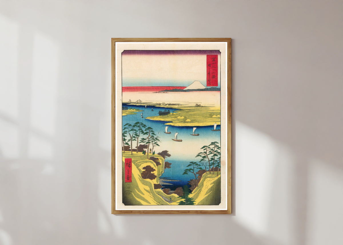 Framed art print of Wild Goose Hill and the Tone River by Utagawa Hiroshige, in a light wood frame on a sunlit white wall