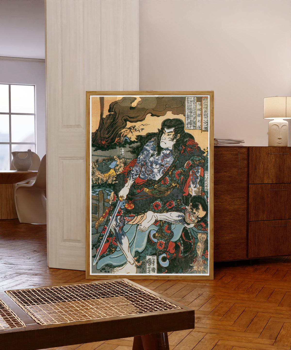 Framed art print of 108 Heroes of the Suikoden: Kumonryū Shishin by Utagawa Kuniyoshi, in a light wood frame leaning in a warm room with a parquet floor