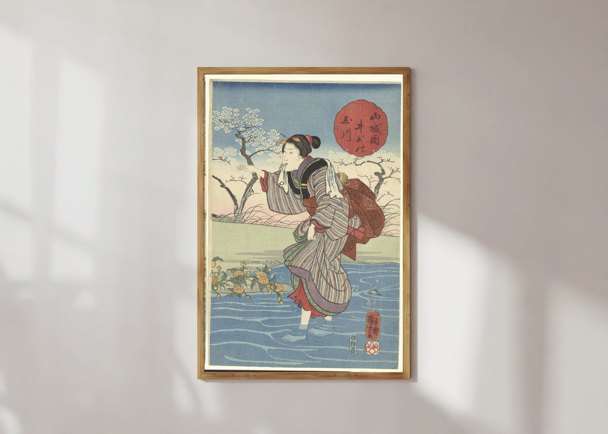 Framed art print of The Ide Tama River in Yamashiro Province by Utagawa Kuniyoshi, in a light wood frame on a sunlit white wall