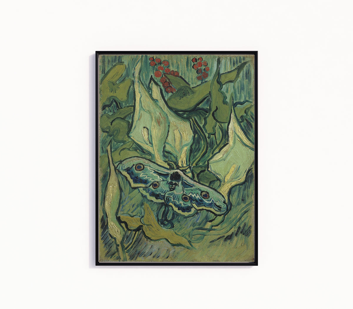 Framed art print of Giant Peacock Moth by Vincent van Gogh, in a slim black frame on a plain white wall