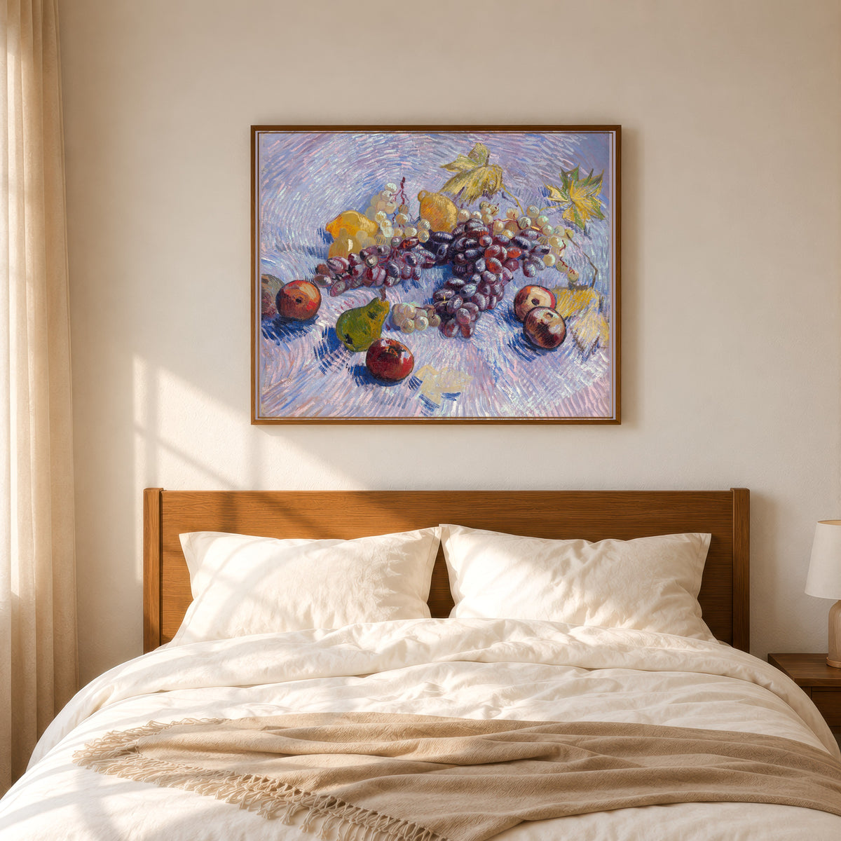 Framed art print of Grapes, Lemons, Pears and Apples by Vincent van Gogh, in a slim wood frame above a bed in a sunlit bedroom
