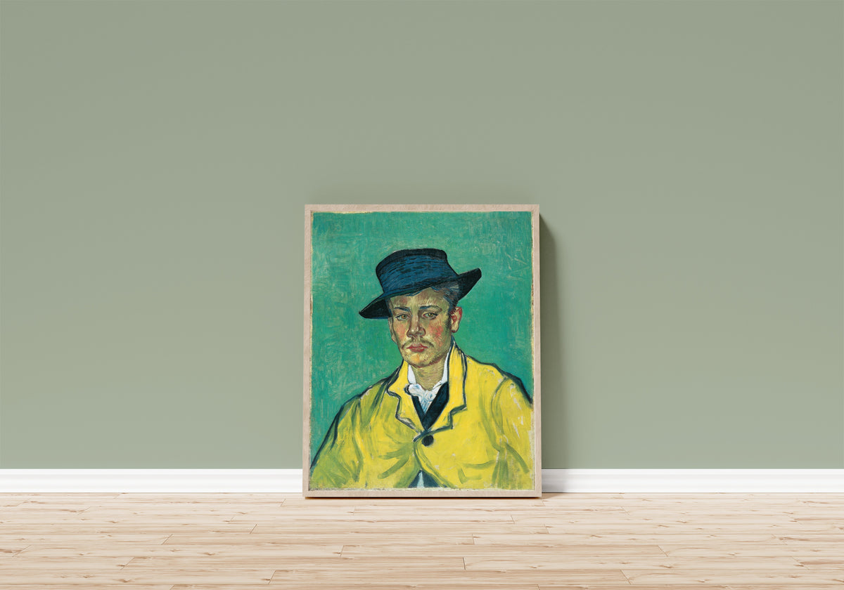 Framed art print of Portrait of Armand Roulin (Yellow Jacket) by Vincent van Gogh, in a light wood frame leaning on a sage green wall above a wooden floor