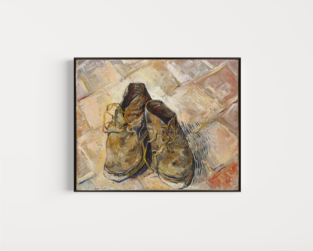 Framed art print of Shoes by Vincent van Gogh, in a slim black frame on a plain white wall