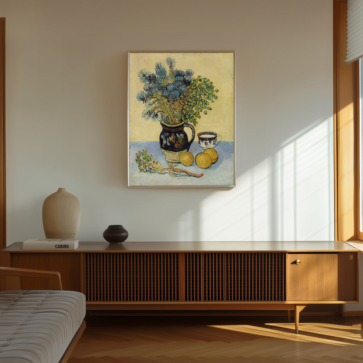 Framed art print of Still Life by Vincent van Gogh, in a thin light frame on a sunlit wall above a wooden sideboard