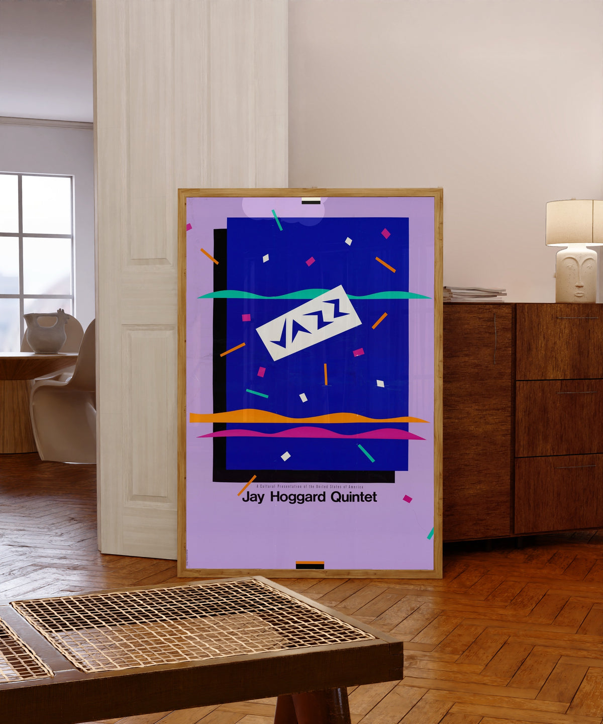 Framed art print of Jay Hoggard Quintet by USIA, in a light wood frame leaning in a warm room with a parquet floor