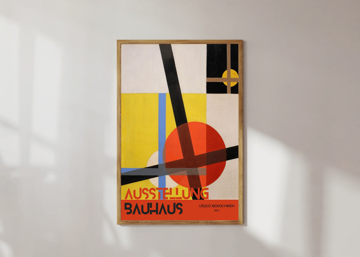 Framed art print of AM 2 by László Moholy-Nagy, in a light wood frame on a sunlit white wall