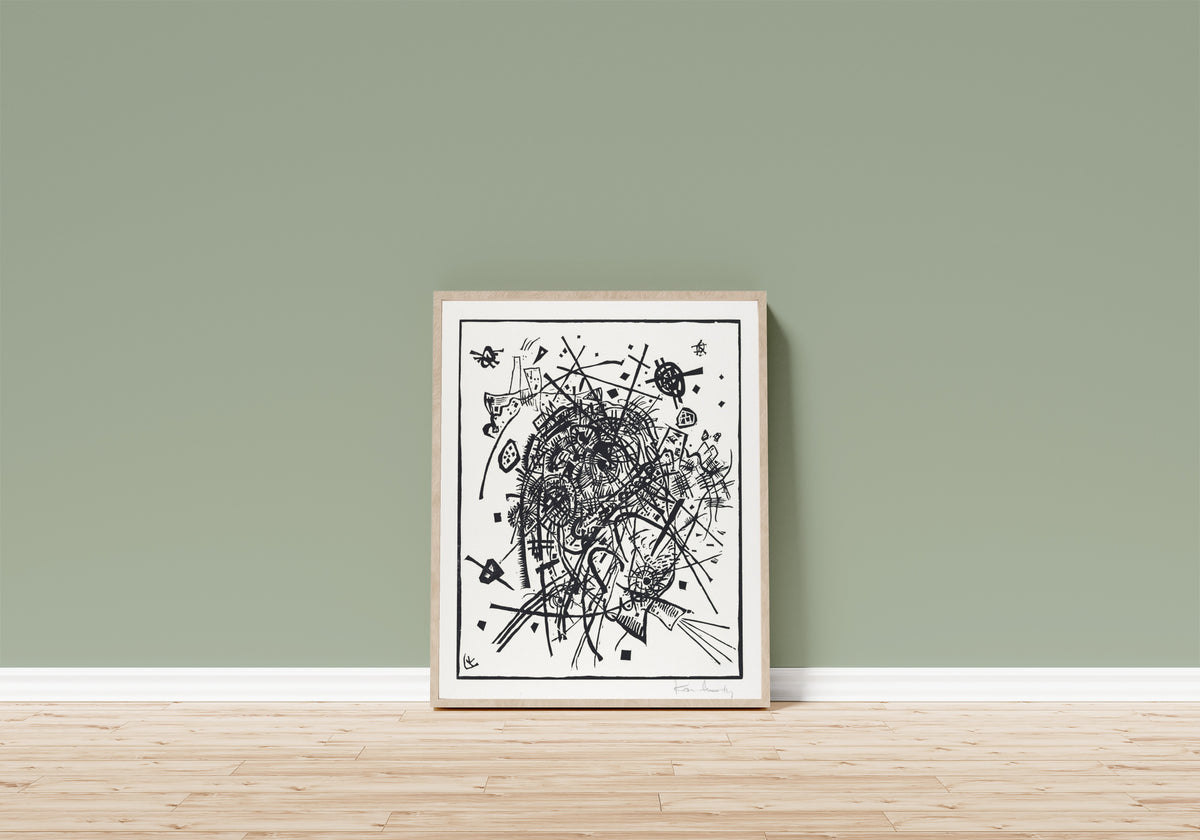 Framed art print of Small Worlds VIII by Wassily Kandinsky, in a light wood frame leaning on a sage green wall above a wooden floor