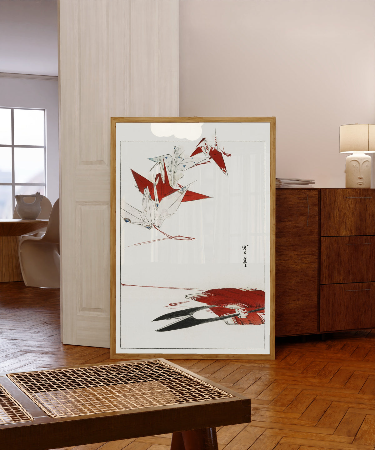 Framed art print of Bird Origami by Watanabe Seitei, in a light wood frame leaning in a warm room with a parquet floor