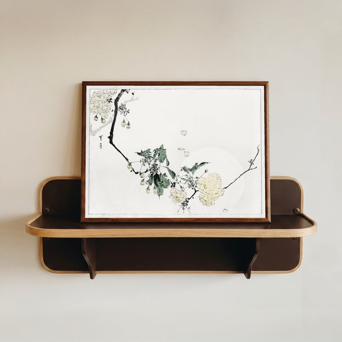 Framed art print of Cherry Blossom by Watanabe Seitei, in a dark wood frame resting on a wall shelf