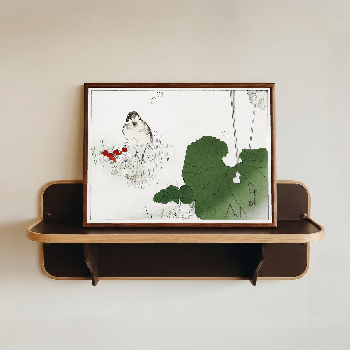 Framed art print of Eurasian tree sparrow by Watanabe Seitei, in a dark wood frame resting on a wall shelf