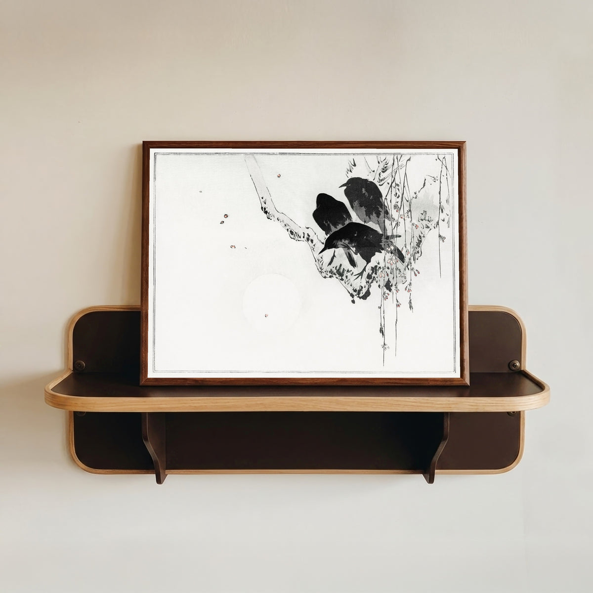 Framed art print of Japanese crows perched on a branch by Watanabe Seitei, in a dark wood frame resting on a wall shelf