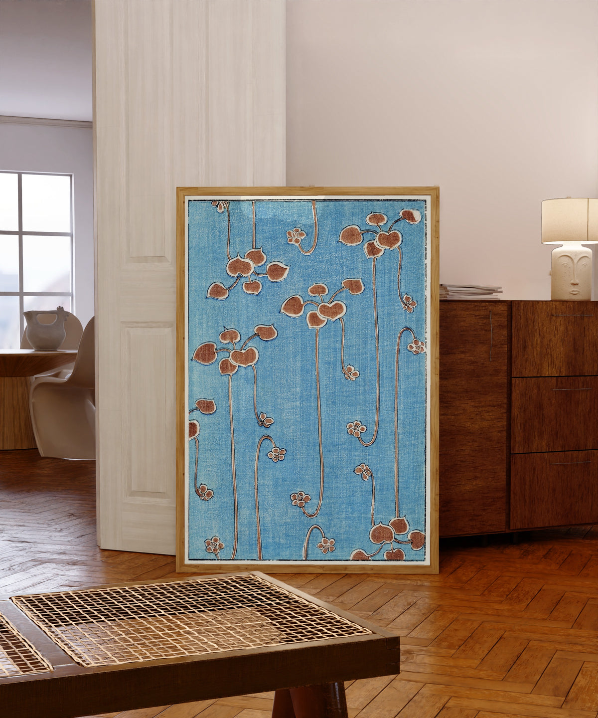 Framed art print of Vine Illustration by Watanabe Seitei, in a light wood frame leaning in a warm room with a parquet floor