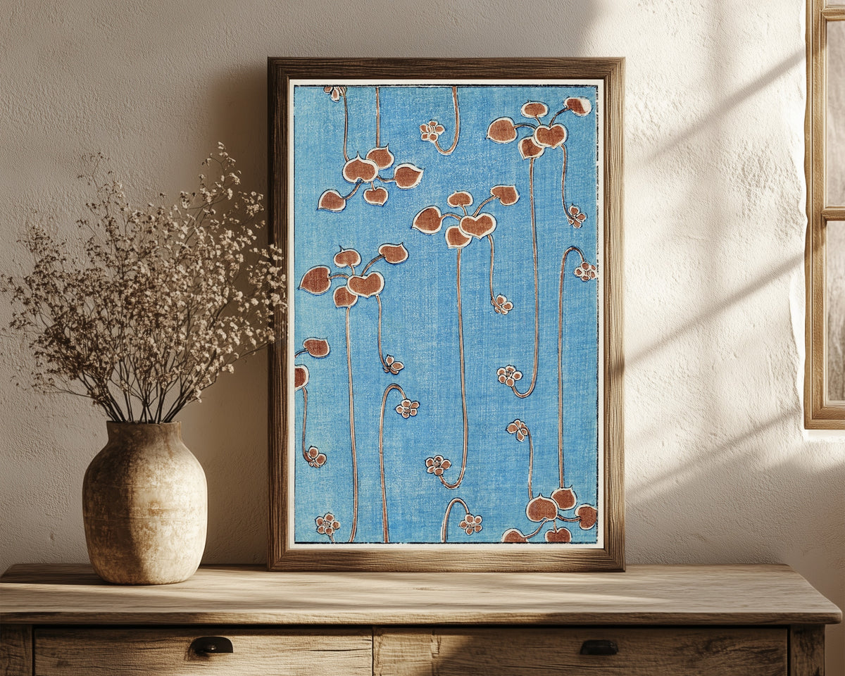 Framed art print of Vine Illustration by Watanabe Seitei, in a dark wood frame leaning on a rustic console beside dried flowers