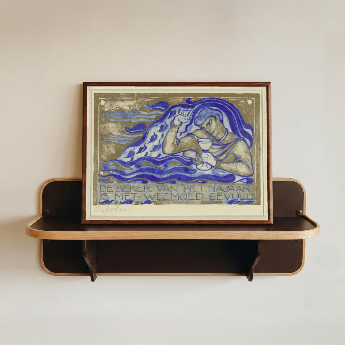 Framed art print of De beker van het najaar is met weemoed gevuld, october [The cup of autumn… by Willem Arondéus, in a dark wood frame resting on a wall shelf