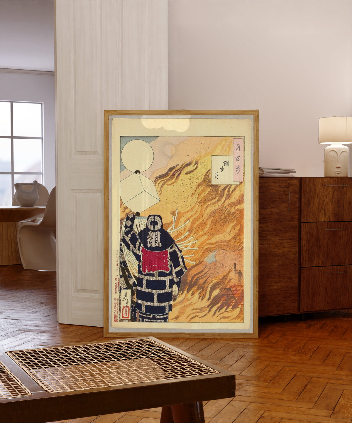 Framed art print of Moon and Smoke by Tsukioka Yoshitoshi, in a light wood frame leaning in a warm room with a parquet floor