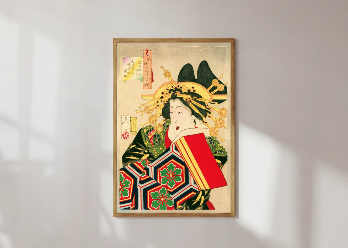 Framed art print of The Geisha by Tsukioka Yoshitoshi, in a light wood frame on a sunlit white wall